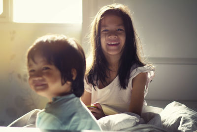 Portrait of smiling girl sitting at home