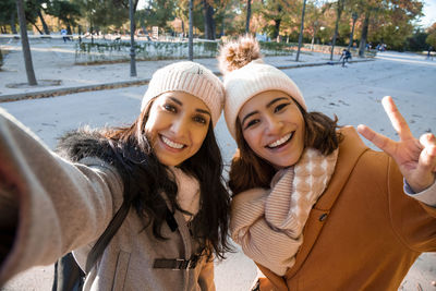 Best friends taking a self-portrait in the park in the fall