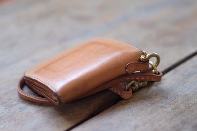 High angle view of leather purse on wooden table