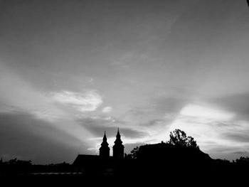 Low angle view of silhouette building against sky during sunset