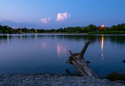 Scenic view of lake against sky at sunset