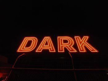 Close-up of illuminated text against black background with bark text.