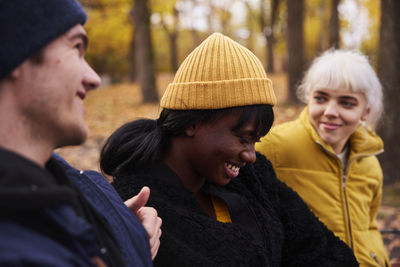 Three friends in park in autumn scenery