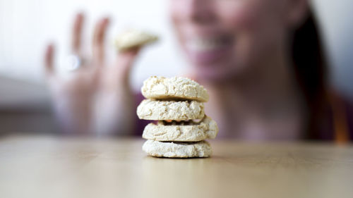 Full frame shot of cookies on table with female in the background