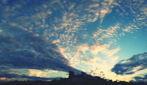 Low angle view of cloudy sky at sunset