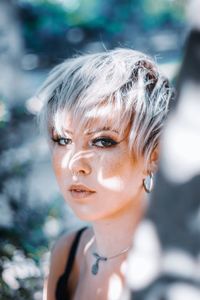 Close-up portrait of young woman looking away