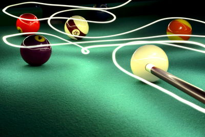 Close-up of balls on pool table with light painting