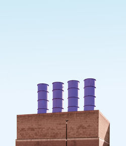Low angle view of factory against clear sky