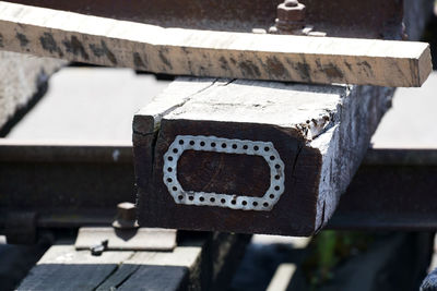 Close-up of information sign on railing