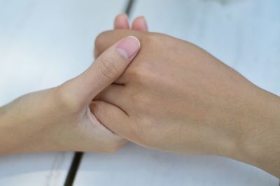 Close-up of couple holding hands