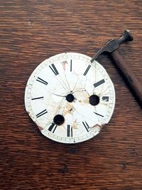 Close-up of clock on wood