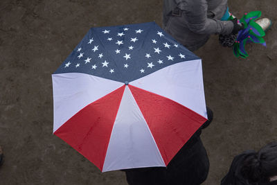 High angle view of people with multi colored umbrella on street