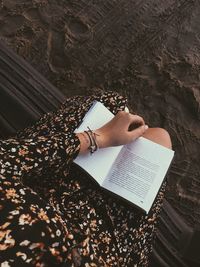 High angle view of woman reading book