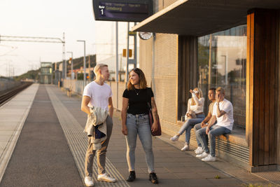 Young friends on train station platforms