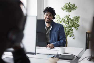 Smiling young man working in call center