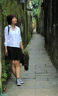 Full length of woman walking on road