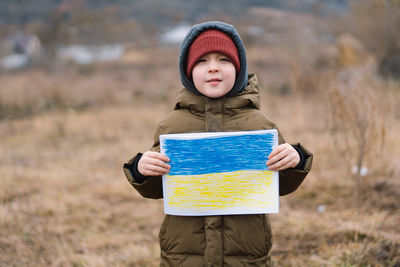 War of russia against ukraine. ukrainian crying boy asks to stop the war in ukraine.