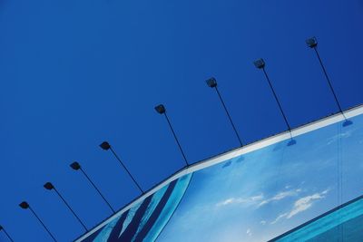 Low angle view of street light against clear blue sky