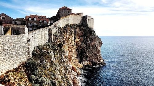 Panoramic view of sea and buildings against sky