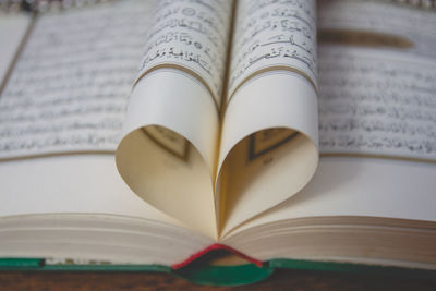 Close-up of koran on table