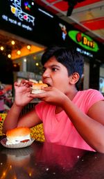 Close-up of young woman eating food