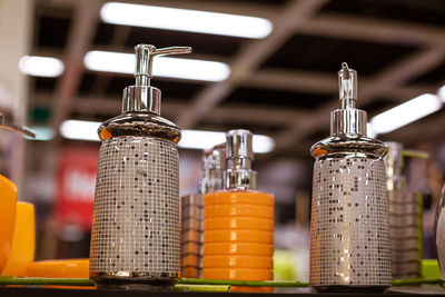 Glass liquid soap dispenser on a shelf in a store