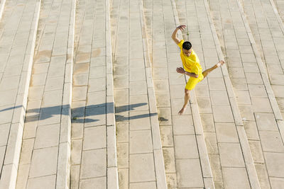 High angle view of woman walking on footpath