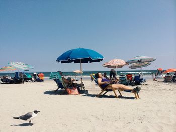 People relaxing on beach