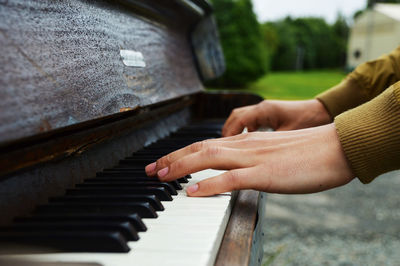 Close-up of hands playing piano