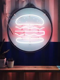 Illuminated light bulb on wall