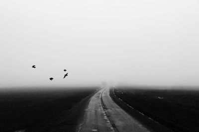 Scenic view of landscape against sky during foggy weather