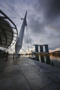 View of cranes against cloudy sky