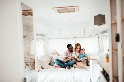 Cheerful family siting in camper van