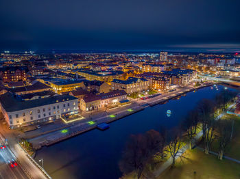 High angle view of illuminated cityscape against sky at night