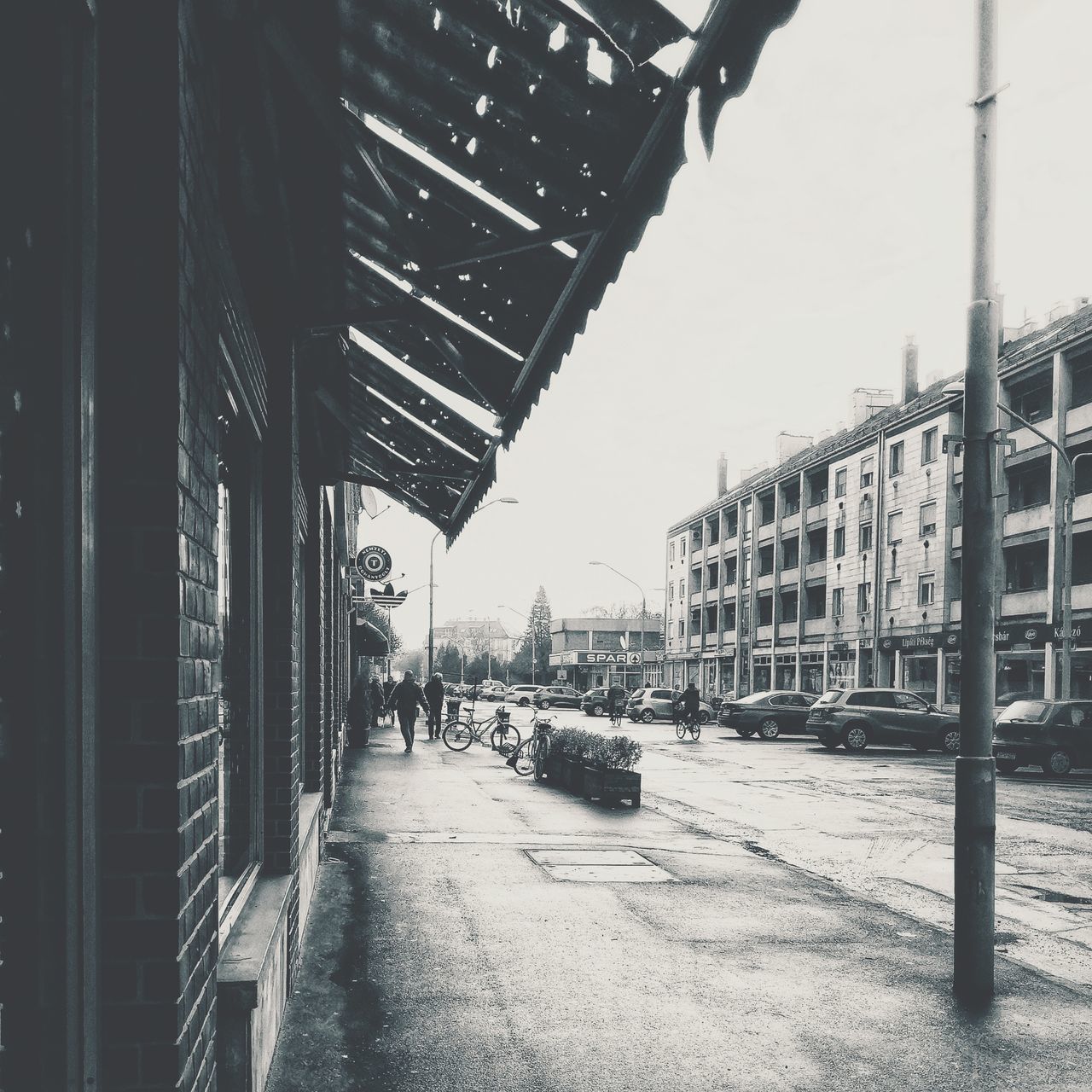 MAN WALKING ON ROAD AGAINST SKY