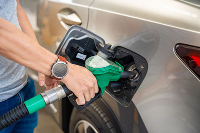 Midsection of man washing car