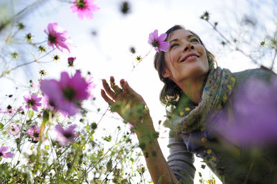 Portrait of women smelling on wild flower, flower meadow