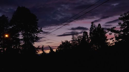 Silhouette trees against sky at sunset