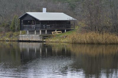 House by lake against building