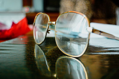 Close-up of old vintage grandma's glasses on table