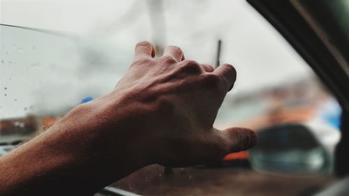 Close-up of man hand holding car