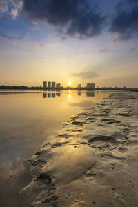 Scenic view of frozen sea against sky during sunset