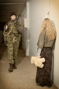 Army soldier with civilian in abandoned house