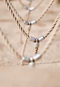 Close-up of metal hanging on ropes