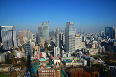 Aerial view of modern buildings against blue sky