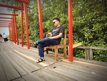 Full length of man sitting on chair