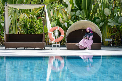 Man sitting in swimming pool