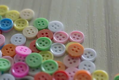 Close-up of multi colored buttons on table