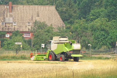 Combine harvester working on field