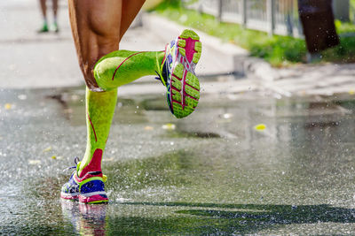 Low section of woman splashing water